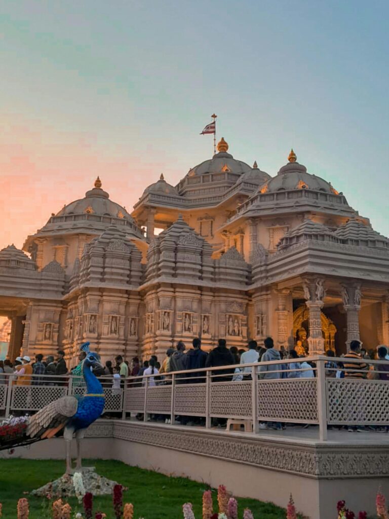 Explore the stunning architecture of Akshardham Temple during a vibrant sunset.